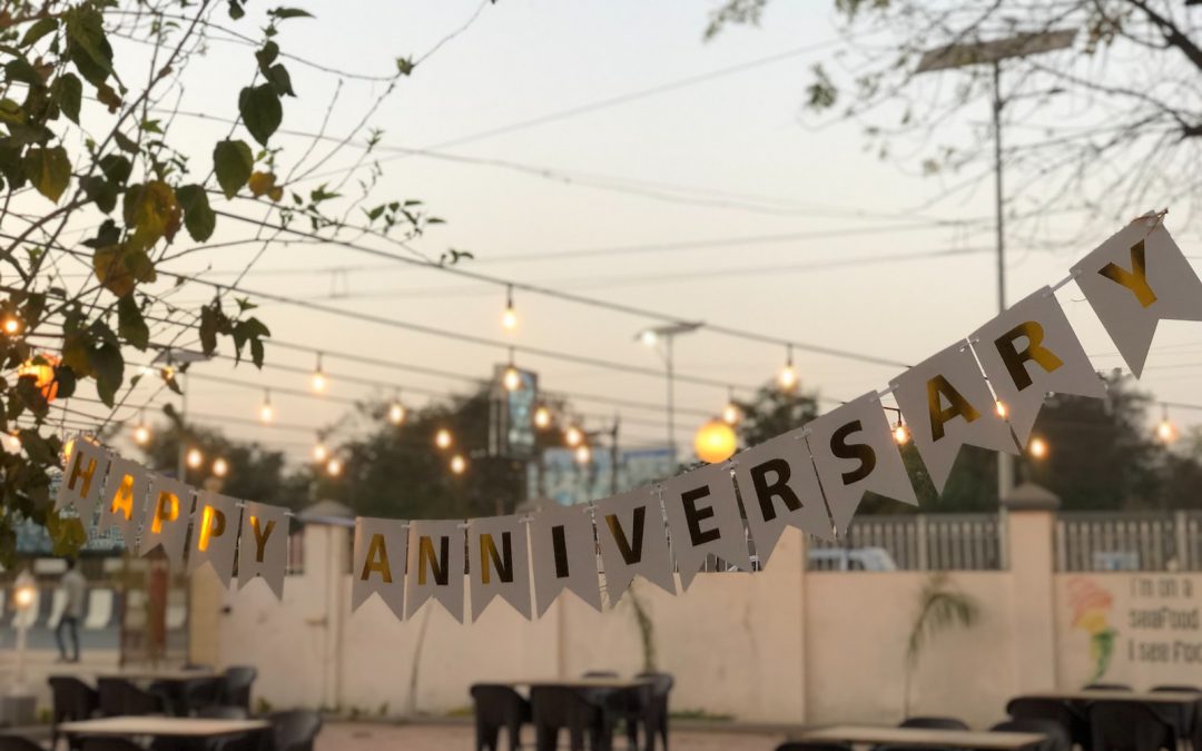 a party banner hanging over a table in a restaurant